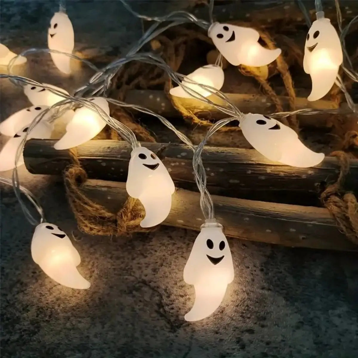Boo Glow ghost string lights glowing among wooden display props